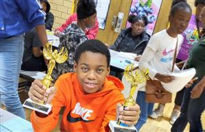 Student posing with the trophies
